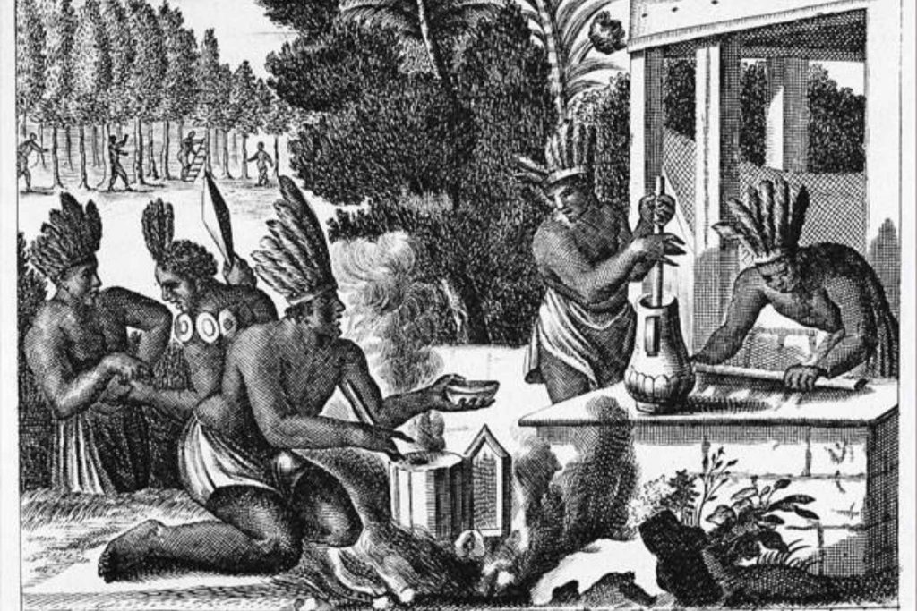 Un grabado antiguo que muestra a indígenas preparando la bebida de cacao. La nota explora el origen del chocolate como un "alimento de los dioses" en el México prehispánico.